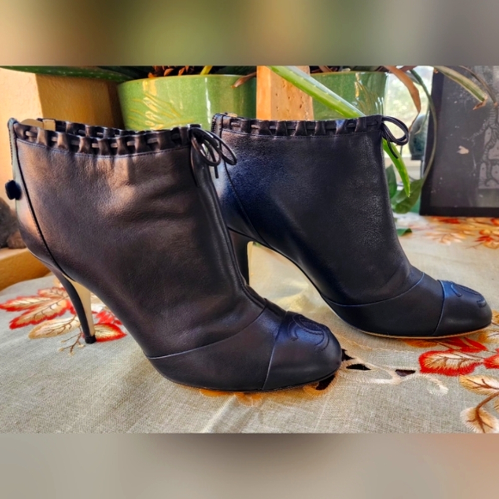 CHANEL Black Ankle Boots with Emblem Toe Cap and Elegant Ruffle at the Top
